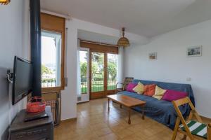 a living room with a blue couch and a table at Ñ-13 CALELLA DE PALAFRUGELL 4 PAX in Calella de Palafrugell