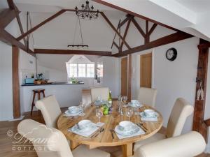 a dining room with a wooden table and chairs at Old Coastguard Apartment 3 in Weymouth