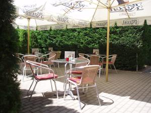 a table and chairs under an umbrella on a patio at Salur in Nové Zámky