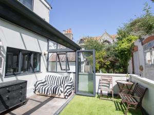 a patio with two chairs and a table at Sailor's Watch in Weymouth