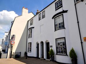 ein weißes Gebäude am Straßenrand in der Unterkunft The Ferryman in Weymouth