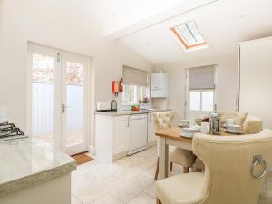 a kitchen and dining room with a table and chairs at Harbour Watch 2 in Weymouth