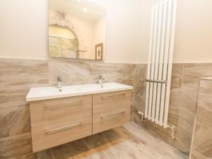 a bathroom with a sink and a mirror at Harbour Watch 2 in Weymouth +10 photos