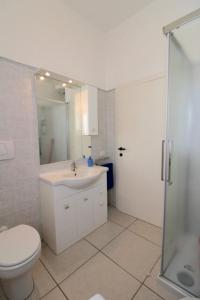 a bathroom with a toilet and a sink and a shower at Rif. B12 - DELFINO 2 in San Vincenzo