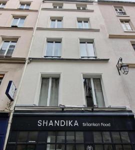 a tall building with a sign for a shamblikia restaurant at S02434 - Montorgueil Studio in Paris
