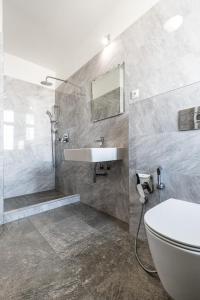 łazienka z umywalką, toaletą i wanną w obiekcie Teplice Apartments U Schodů w Cieplicach