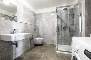 a bathroom with a sink and a shower at Teplice Apartments U Schodů in Teplice
