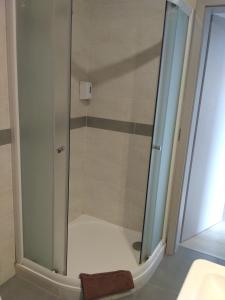 a shower with a glass door in a bathroom at Apartments 4U center + free parking in Olomouc