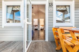 a porch with a table and a dining room at Chłopy Beach Resort in Chłopy