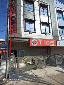 a building with a t tops sign on the side of it at Dormitory in Udaipur