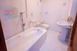 a bathroom with a tub and a toilet and a sink at CASA CHIARINA breathtaking sea view in Ravello +20 photos