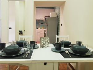 a kitchen with a table with plates and utensils on it at GISELLE in Naples
