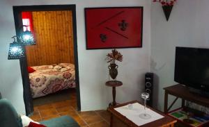 a living room with a room with a bed and a tv at Casa Armando in Icod de los Vinos