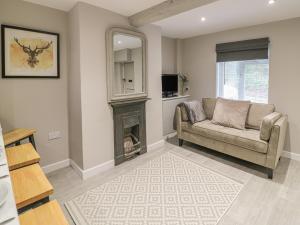 a living room with a couch and a fireplace at 5 Coley Lane in Stafford
