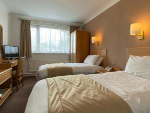 Postel nebo postele na pokoji v ubytování Birmingham Great Barr Hotel