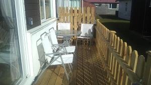 a patio with two chairs and a table and a fence at SJ Seaside Chalet in Bridlington