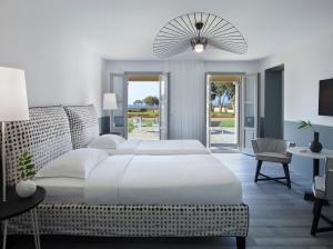 A bed or beds in a room at Kalimera Kriti Hotel & Village Resort