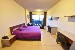 Postel nebo postele na pokoji v ubytování VU'Z Hotel + 25 fotografií