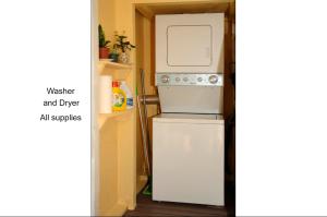 a small kitchen with a refrigerator and a microwave at Quaint Historic Downtown Apartment in Saint Augustine