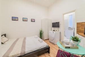 a bedroom with a bed and a table in it at Real Apartments Anker II in Budapest