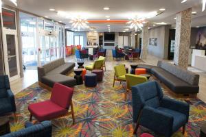 a lobby with couches and chairs and tables at La Quinta Inn & Suites by Wyndham Braselton in Braselton