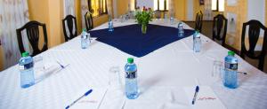 a table with bottles of water on top of it at The Last Village Lodge in Athi River +151 photos