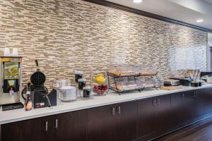 a kitchen with a counter with food on it at La Quinta by Wyndham Memphis Wolfchase in Memphis