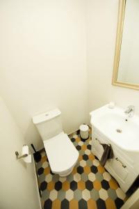 a bathroom with a white toilet and a sink at Lossi 32 Lux Apartment in Tartu +21 photos
