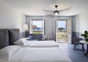 A bed or beds in a room at Kalimera Kriti Hotel & Village Resort