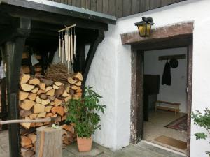 una pila de leña al lado de un edificio en Cosy holiday home in Kollnburg with garden, en Achslach