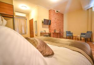 A bed or beds in a room at Maravilloso Hotel Pera