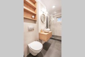 a bathroom with a toilet and a sink at Briana Luxury Sky View Studio in Cluj-Napoca