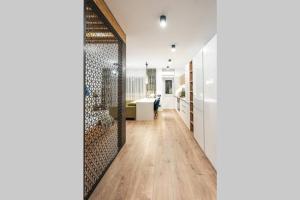 a hallway with white walls and a wooden floor at Briana Luxury Sky View Studio in Cluj-Napoca