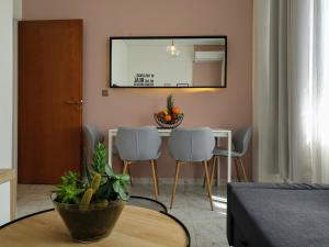 a living room with a dining room table and chairs at City House Elegant in Kalamata