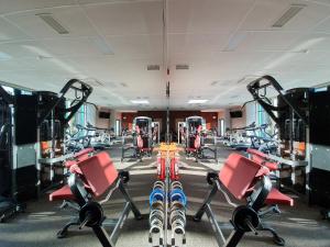 a gym with skis and exercise bikes in it at Toila Spa Hotel in Toila