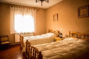 מיטה או מיטות בחדר ב-Casa La Escondida