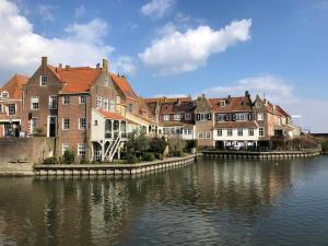 a group of buildings next to a body of water at Boot & Breakfast - slapen op het water in Enkhuizen