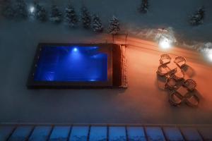 a swimming pool with blue lights on the side of a building at Gudauri Lodge in Gudauri
