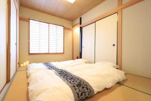 a large white bed in a room with a window at RKT4bedroom ForFamily 30mins Shibuya and Azabu in Tokyo
