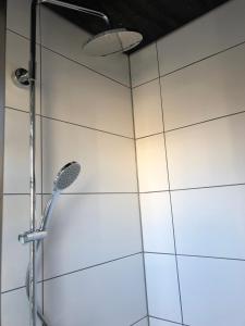 a shower with a shower head in a bathroom at Boot & Breakfast - slapen op het water in Enkhuizen