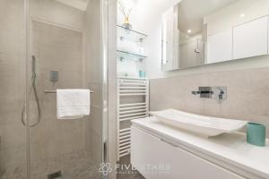 a white bathroom with a sink and a shower at Suite Versailles Five Stars Holiday House in Nice +34 photos