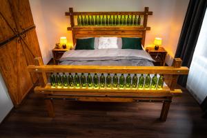 ein Schlafzimmer mit einem Bett und einer Bank mit Flaschen in der Unterkunft Dům u lázní in Znojmo