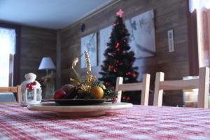 a christmas tree with a plate of fruit on a table at Il Pino B&B in Alpe Devero