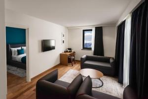 a living room with a couch and a bed at Gudauri Lodge in Gudauri