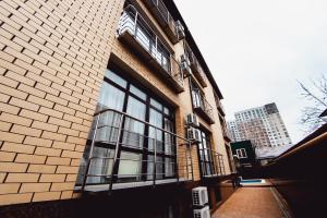 a brick building with windows on the side of it at Hotel Orion Plus in Anapa