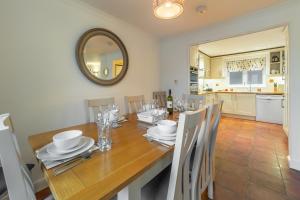 a dining room with a wooden table and a mirror at Waterfront House in Saint Clement