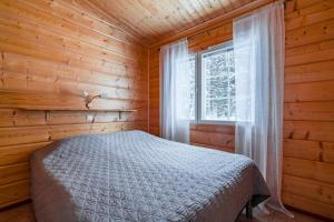 Postel nebo postele na pokoji v ubytování Lomaperkkiö Apartments