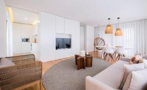 a living room with a couch and a table at Aqua - Pópulo Eco Village in Ponta Delgada