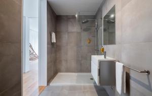 a bathroom with a shower and a white sink at Aqua - Pópulo Eco Village in Ponta Delgada