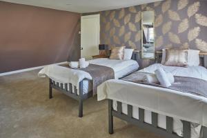 a bedroom with two beds and a mirror at Opposite to Sally Lunn's Spacious Luxury Maisonette! in Bath
